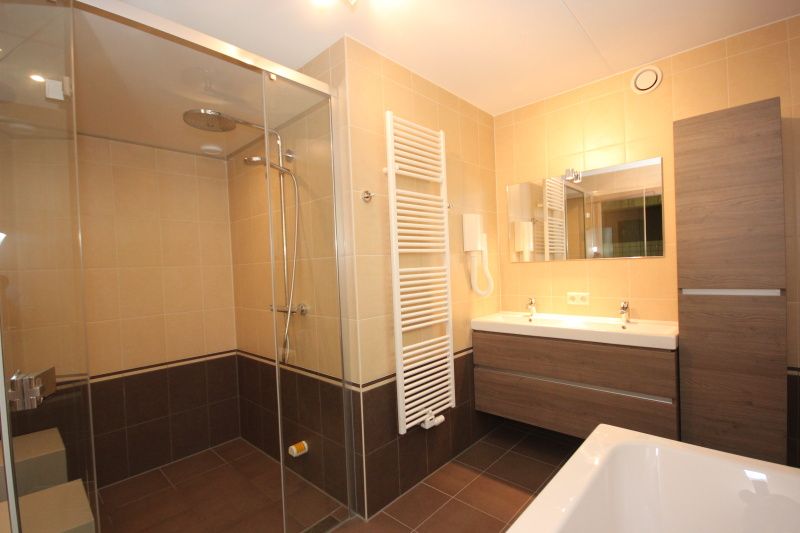 Luxury bathroom in Villa De Witte Hoek 138 conservatory, De Cocksdorp Texel, vacation home with modern shower and double sink.