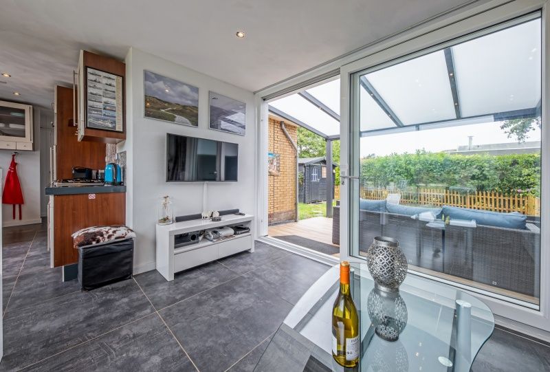 Modern interior of Bungalow Duin aan Zee Texel, Bungalowpark Tamarisk, De Cocksdorp with access to the terrace.