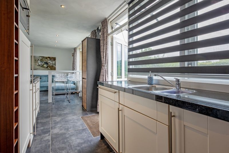 Functional kitchen area in Bungalow Duin aan Zee Texel, Bungalowpark Tamarisk, De Cocksdorp with modern amenities.