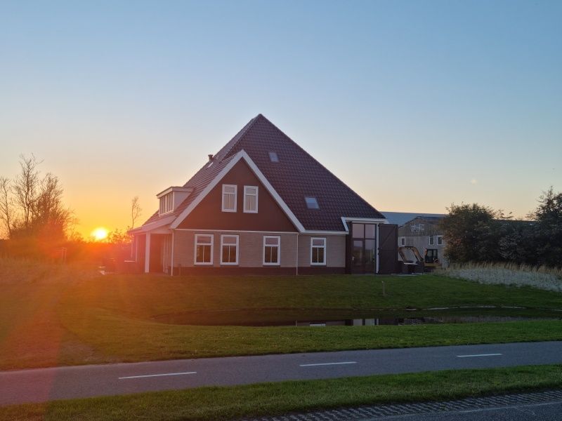 Ervaar een adembenemende zonsondergang bij Vakantiehuis De Slufter in De Cocksdorp, Texel, met een schilderachtig uitzicht.