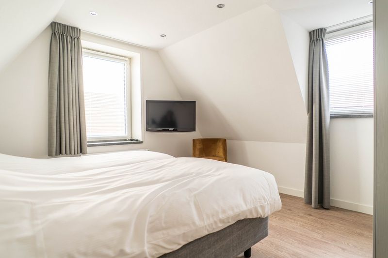 Ruime slaapkamer in Type D Kikkertstraat, vakantiehuis in De Cocksdorp, Texel met comfortabele bedden.