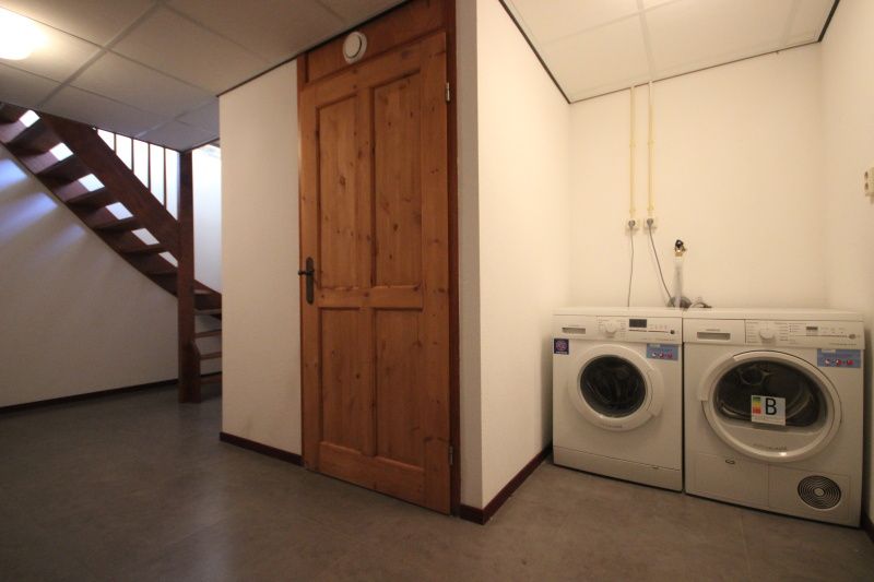 Practical laundry room in Villa De Witte Hoek conservatory, vacation home on Texel.
