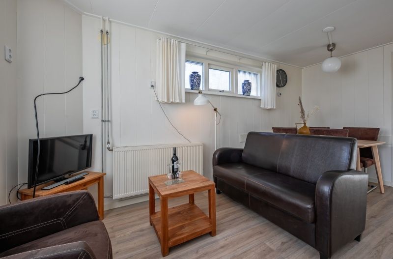 Gemuetliches Wohnzimmer im Ferienhaus Kikkertstraat 60, De Cocksdorp, Texel mit bequemer Sitzgelegenheit.
