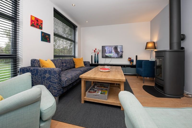 Cozy living room in Holiday home Slufteroord 240, Texel with comfortable seating area and modern furnishings.