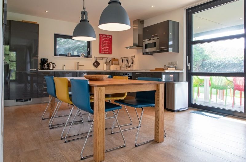 Stylish kitchen in Holiday home Slufteroord 240, Texel with modern appliances and dining area for six.