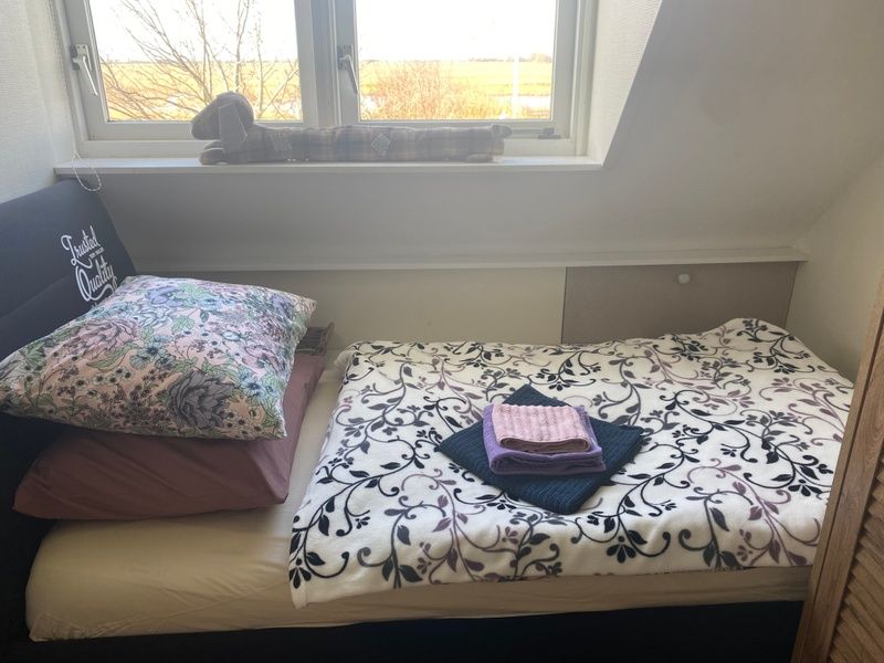 Cozy bedroom in Family House Dacha, De Cocksdorp Texel, overlooking the nature of the Wadden Islands.