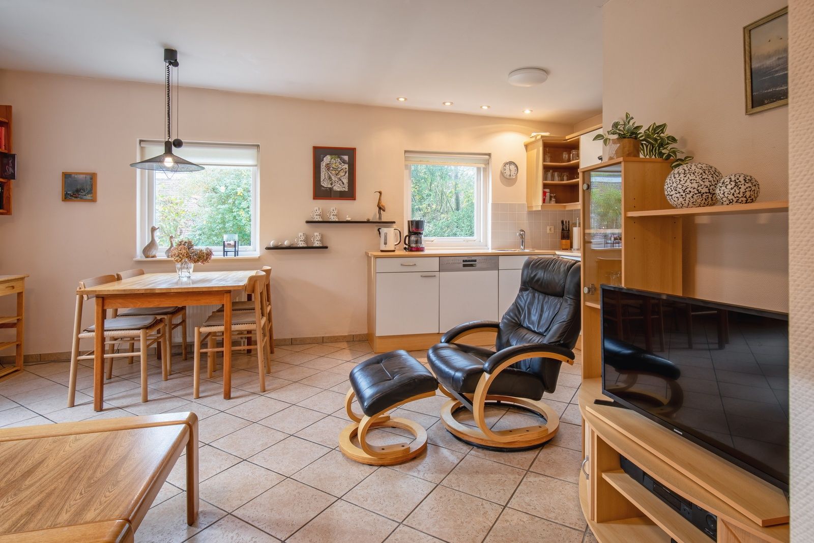 Cozy living room in Holiday home Slufterduin 094, De Cocksdorp, Texel. Comfortable seating area and modern kitchen in a cozy environment.