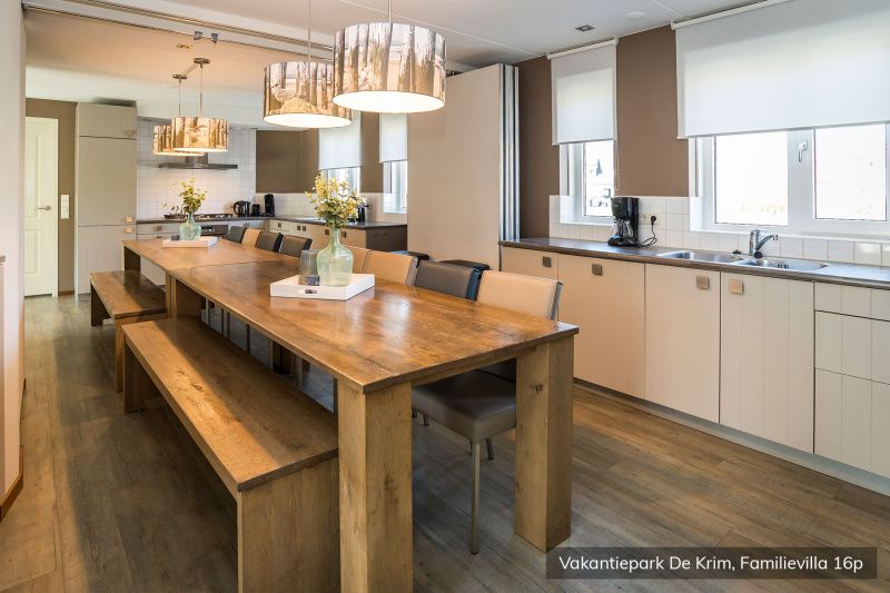 Large dining room in Family Villa 16 persons, De Cocksdorp, Texel with long wooden table.