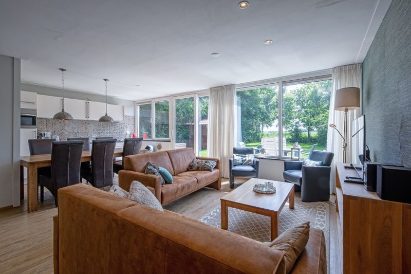 Open living room and kitchen in Holiday home Slufterhoek 132, De Cocksdorp, Texel, perfect for family stays on the Wadden Islands.