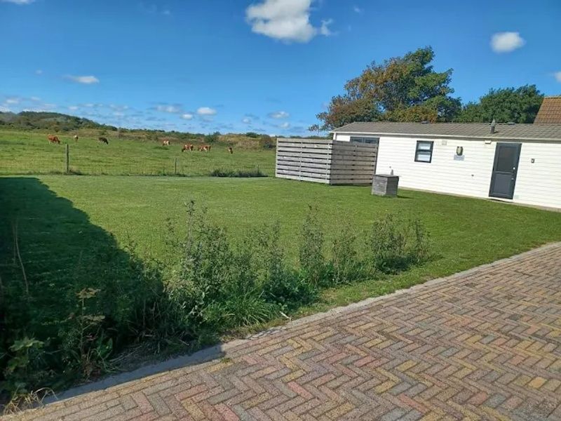 Enjoy the tranquility and green surroundings at Chalet Duunzicht, a vacation home in De Cocksdorp, Texel, overlooking the Wadden Islands.