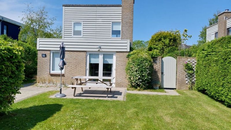 Vakantiehuis B 223 in De Cocksdorp, Texel, met zonnig terras en groene tuin, ideaal voor ontspannen verblijf op de Waddeneilanden.