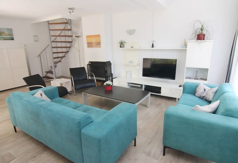 Gezellige woonkamer van Vakantiehuis D 603 in De Cocksdorp, Texel, met moderne inrichting en comfortabele zithoek.