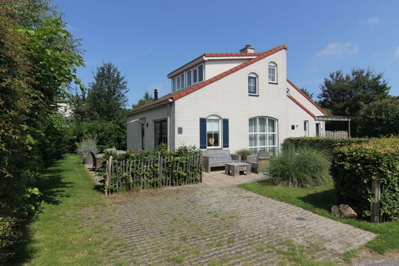 Vacation home D 692 in De Cocksdorp, Texel offers charming accommodation with a sunny terrace and green garden, ideal for a relaxing vacation.