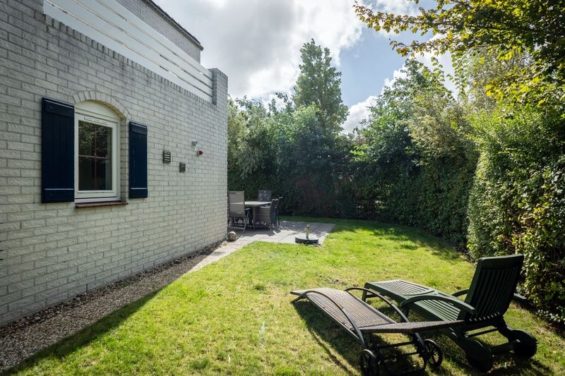 Enjoy the serene garden of Holiday home F 549 in De Cocksdorp, Texel. Relax on the terrace of this charming vacation home on the Wadden Islands.