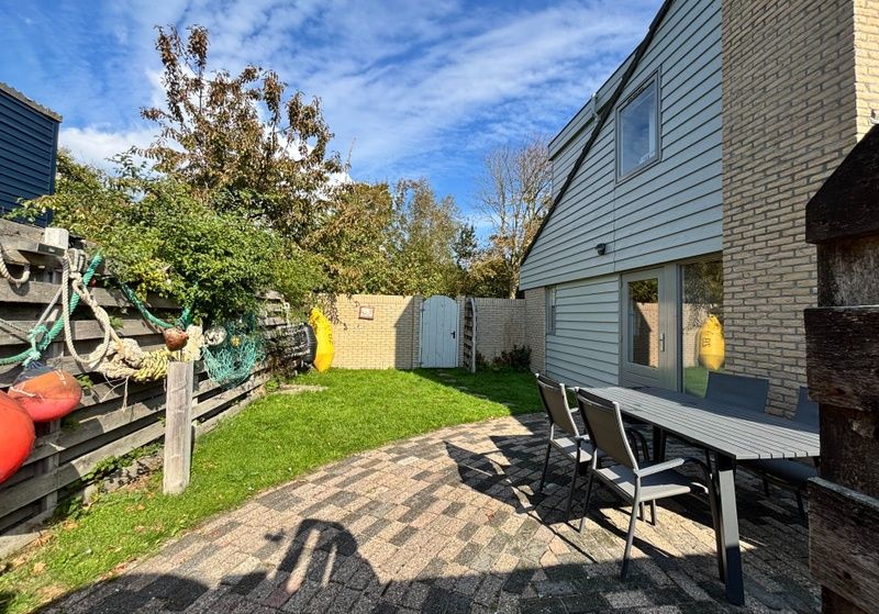 Enjoy the sunny garden at Holiday home B 011 in De Cocksdorp, Texel. Perfect for terrace relaxation in the Wadden Islands.