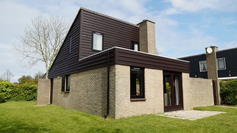 Vakantiehuis B 031 in De Cocksdorp, Texel biedt een charmante buitenkant met groene omgeving, ideaal voor een ontspannen verblijf op de Waddeneilanden.