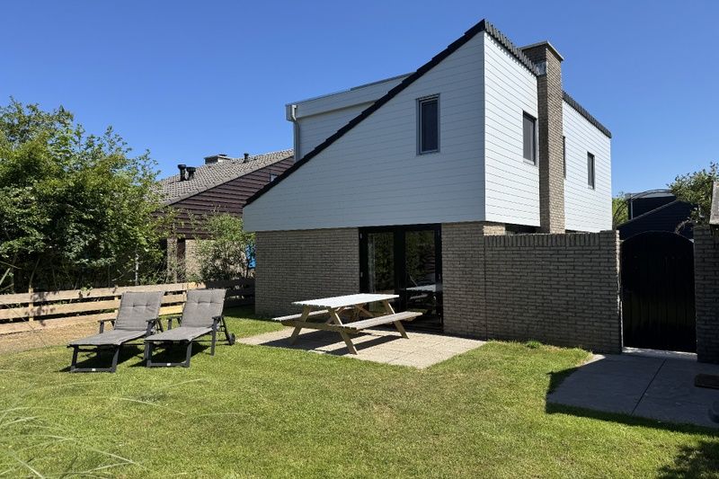 Enjoy the sunny terrace of Holiday home A 301 in De Cocksdorp, Texel, Wadden Islands, surrounded by green nature.