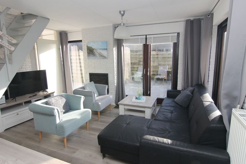 Cozy living room in Holiday home A 301 in De Cocksdorp, Texel. Comfortable sitting area and lots of natural light in this vacation home on the Wadden Islands.