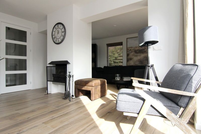 Cozy living room in Holiday home A 075, De Cocksdorp, Texel with modern furnishings and lots of natural light.