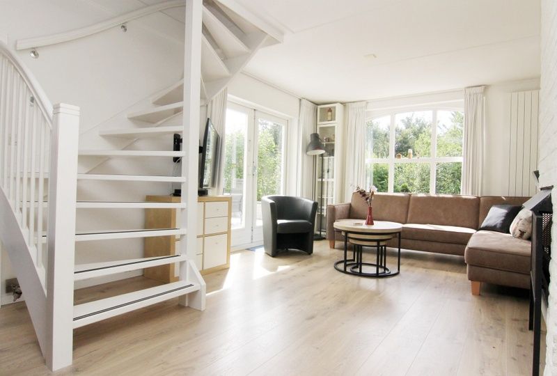 Lichte woonkamer van Vakantiehuis F 759 in De Cocksdorp, Texel, met moderne inrichting en uitzicht op de groene omgeving.