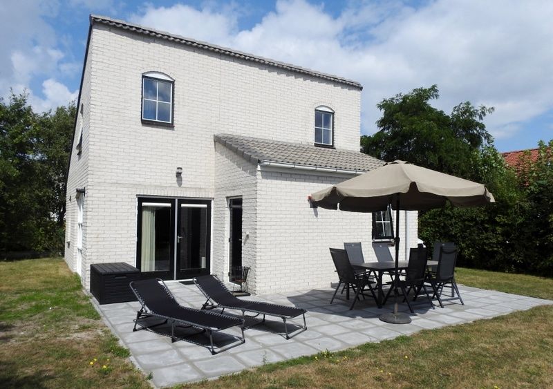 Geniet van het terras van Vakantiehuis E 614 in De Cocksdorp op Texel, een ideale vakantiewoning op de Waddeneilanden met comfortabele ligstoelen.