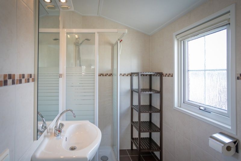 Modernes Badezimmer im Chalet Bregkoog 227, Chaletpark Bregkoog, De Koog, Texel mit Dusche und Waschbecken.