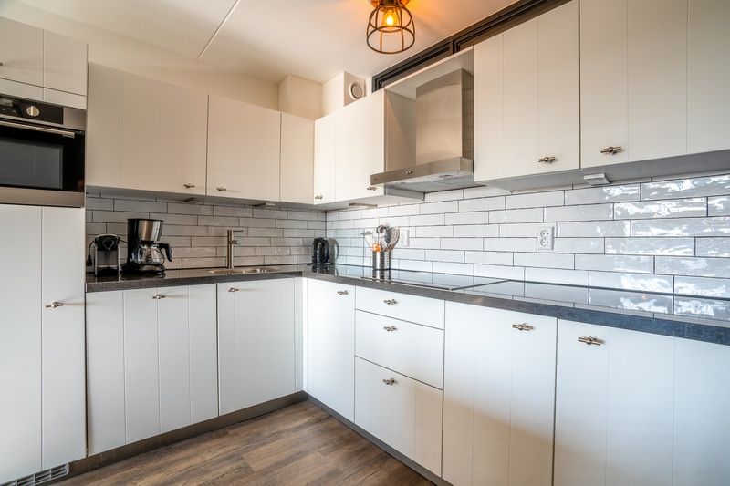 Moderne keuken met witte kasten in Appartement Juliana 048, De Koog, Texel, Waddeneilanden.