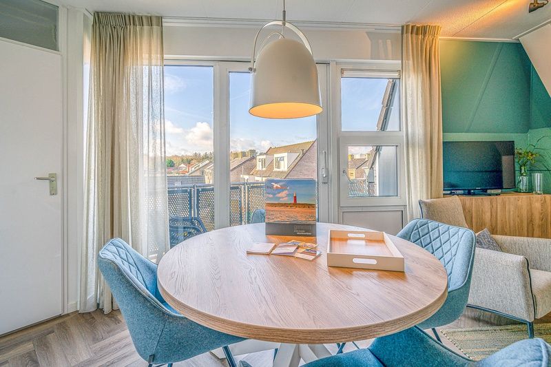 Eettafel met uitzicht in Appartement Zeedistel 22, De Koog, Texel, perfect voor gezellige maaltijden op de Waddeneilanden.