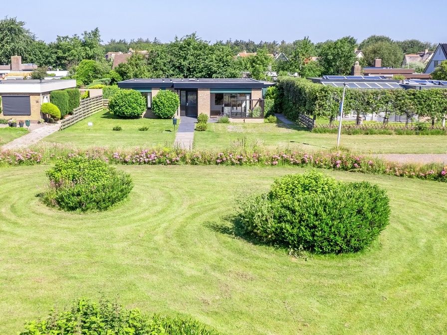 Orchismient 14 vacation home in De Koog Texel with beautiful view of green garden.