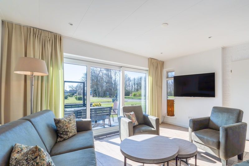 Bright living room in Orchismient 14 vacation home, De Koog Texel with comfortable seating area.