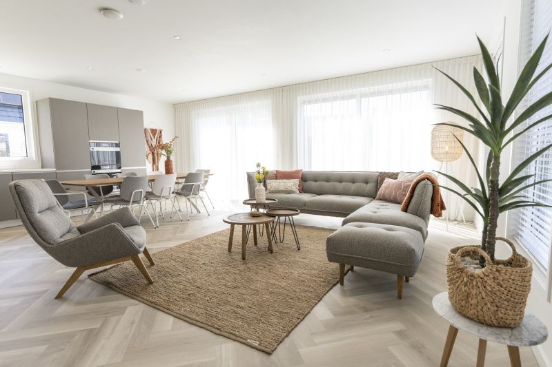 Stylish living room of Villa 19 in De Koog, Texel, with comfortable seating area and lots of light.
