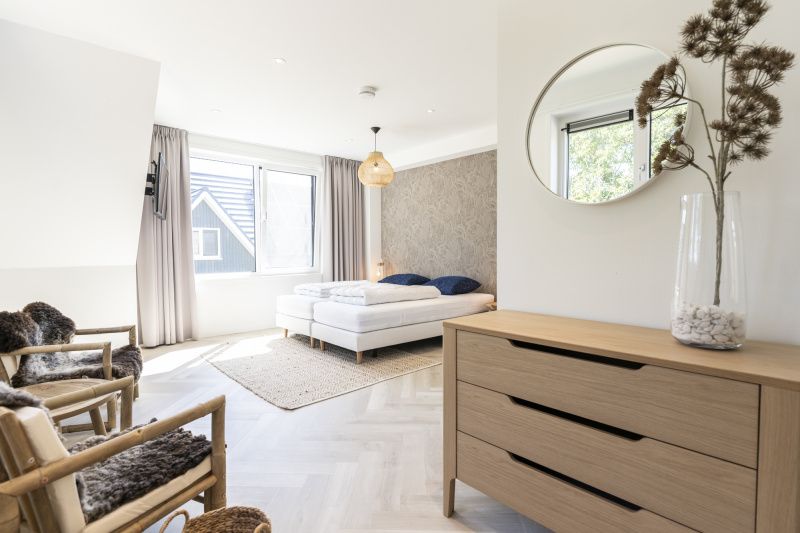 Bright bedroom in Villa 19, De Koog, Texel, with comfortable bed and cozy sitting area.