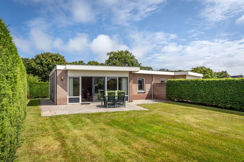 Vacation home Bungalow 31 in De Koog, Texel with sunny terrace and green surroundings.
