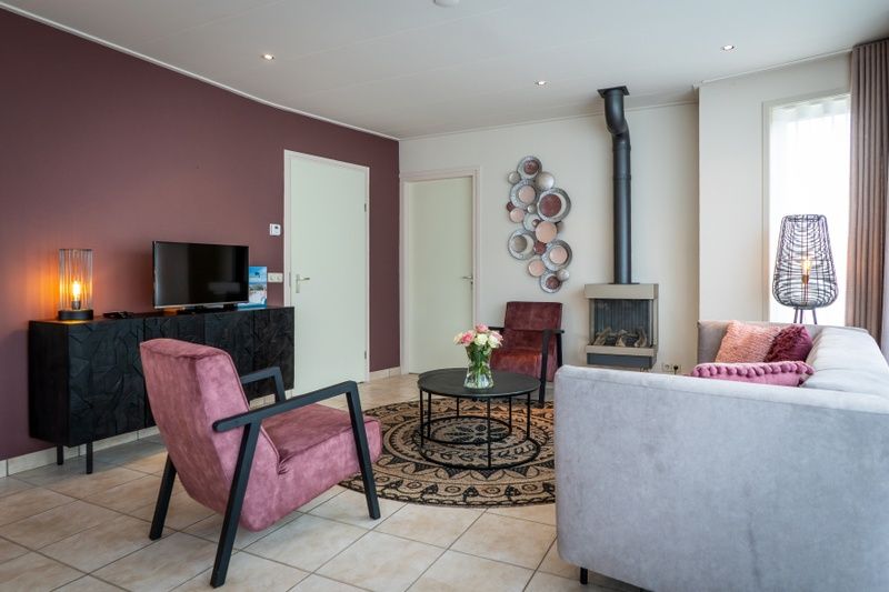 Cozy living room with fireplace in Bungalow 31, De Koog, Texel.