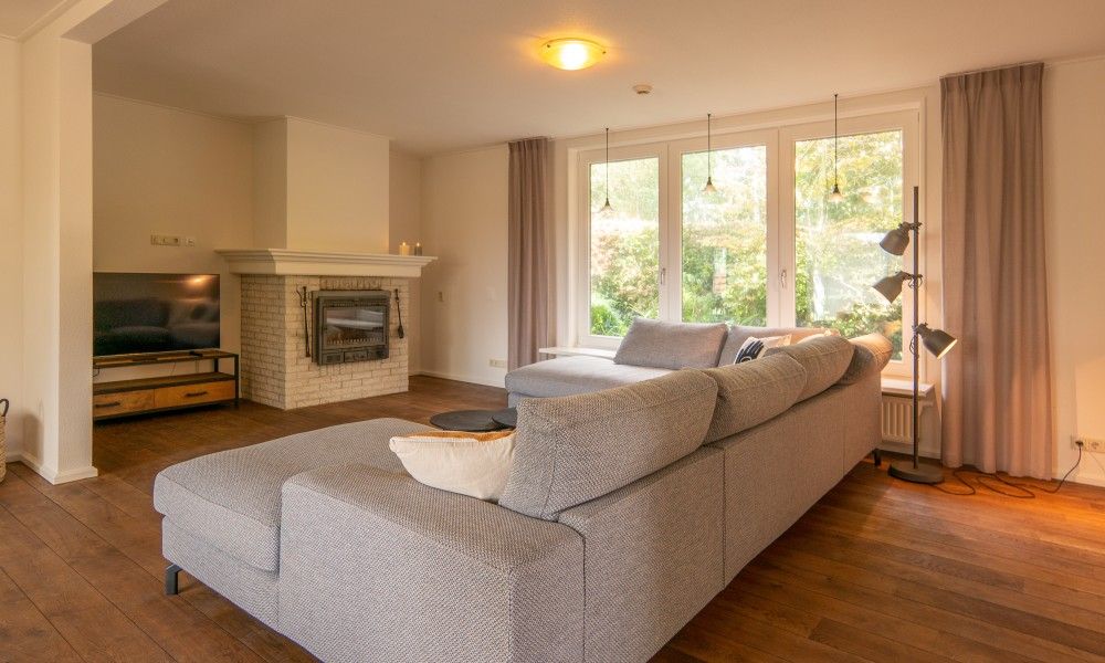 Spacious seating area overlooking the garden in Kamerstraat 66 vacation home in De Koog Texel.