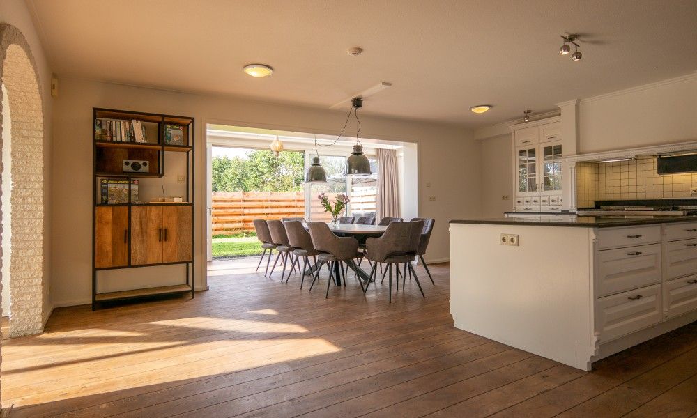Dining room with large table and lots of light in Kamerstraat 66 vacation home in De Koog Texel.