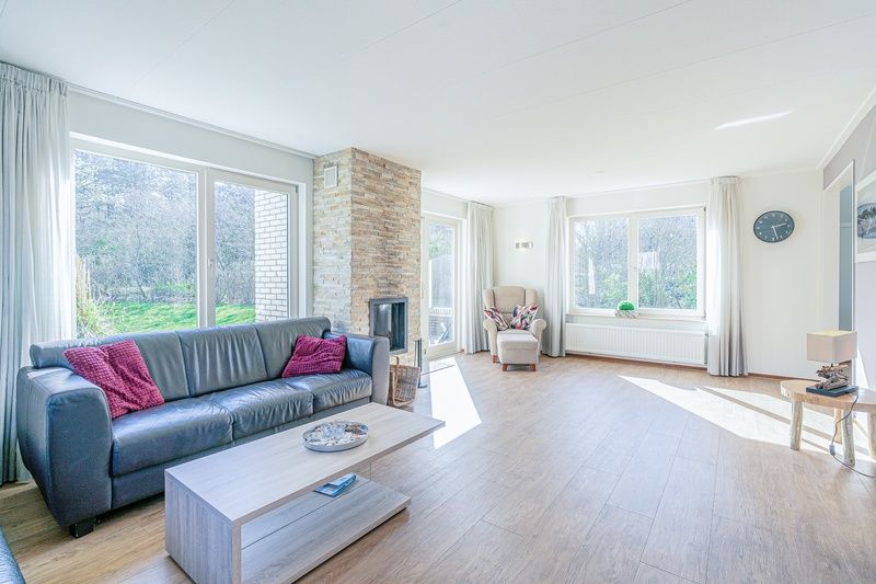 Bright and open living room in Holiday home Honeysuckle 95, De Koog, Texel with views of nature.
