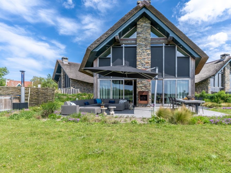 Villa 191 with Hot tub in De Koog, Texel, vacation home with spacious garden and modern terrace for ultimate outdoor fun.