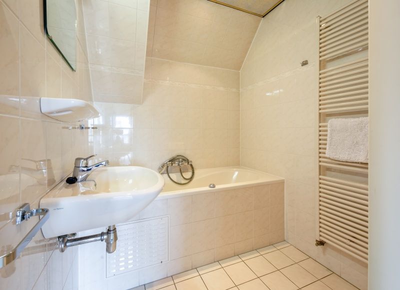 Luxurioeses Badezimmer mit Badewanne im Resort De Buteriggel - Appartement 0, De Koog, Texel, fuer ultimative Entspannung.