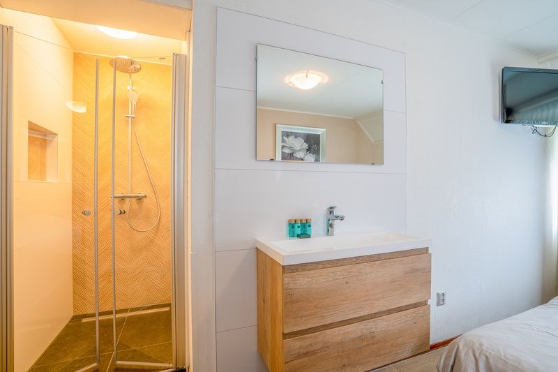 Bright bedroom with skylight in Holiday home Honeysuckle 49, De Koog Texel, for a relaxing stay on the Wadden Islands.