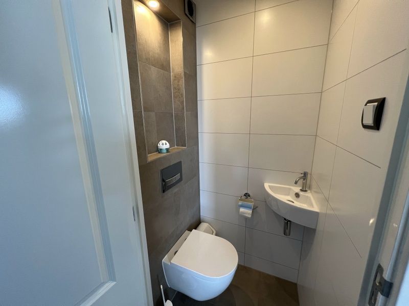 Compact toilet in Vakantiehuis Duinzee Texel, De Koog, met functioneel en modern ontwerp.