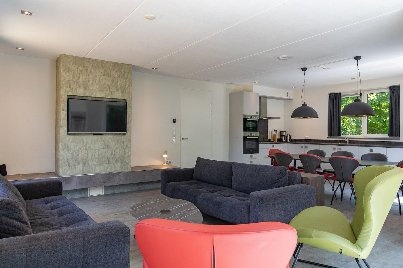 Modern living room in 06 - Razende Bol - allotment vacation home in De Koog, Texel with open kitchen.