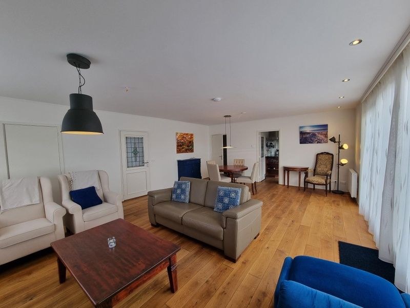 Offener Wohnbereich im Bungalow Epelaan 13, De Koog, Texel. Modern eingerichtetes Ferienhaus mit Holzboeden.