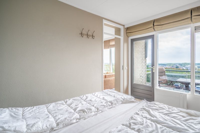 Schlafzimmer mit Balkon in Appartement Juliana 178 Eilandzicht, De Koog, Texel. Entspannen Sie sich in diesem Ferienhaus auf den Watteninseln.