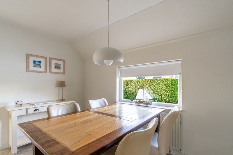 Eetkamer met houten tafel in Vakantiehuis Kamperfoelie 77, De Koog, Texel