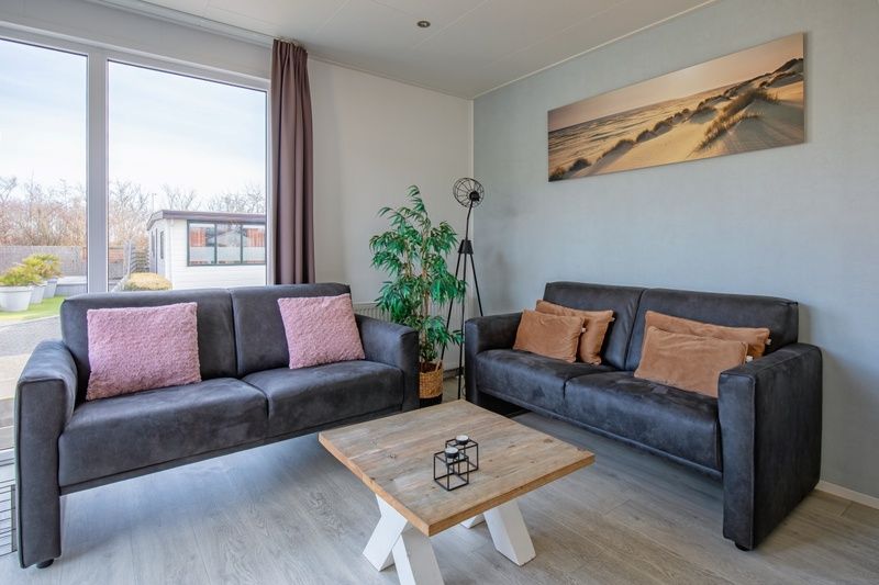 Comfortabele zithoek in Chalet Bregkoog 261, Chaletpark Bregkoog, De Koog, Texel, met uitzicht op de tuin.