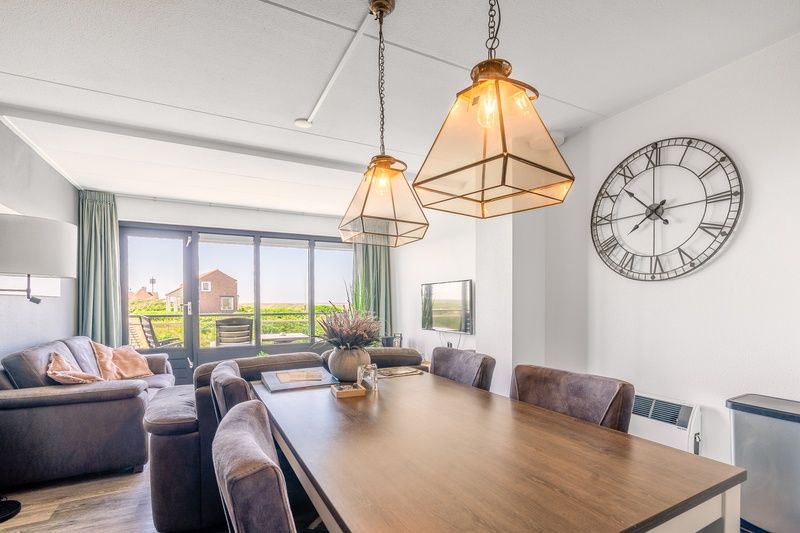 Dining room in Apartment Juliana 094 Island and Sea View, De Koog, Texel with large dining table and nature view.