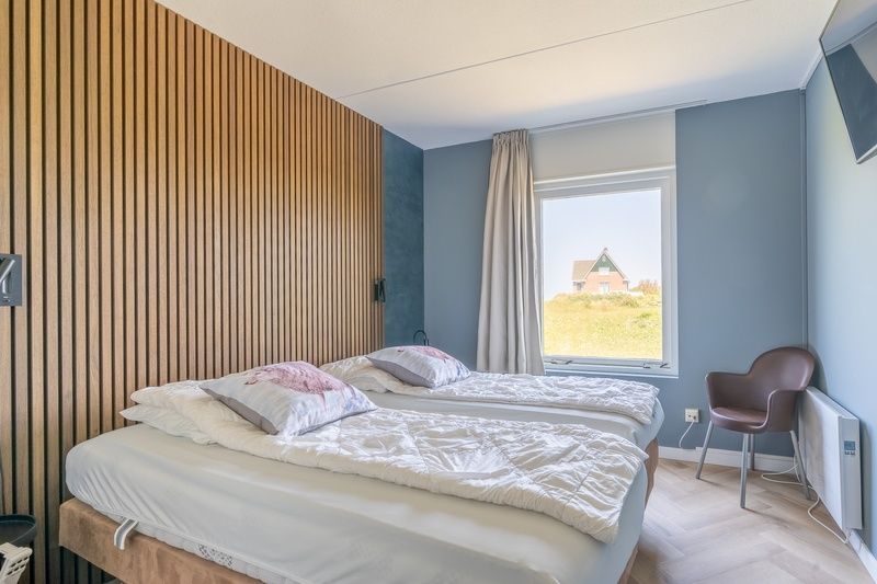 Comfortable bedroom in Apartment Juliana 120 Eilandzicht, De Koog, Texel with double bed and views of nature.