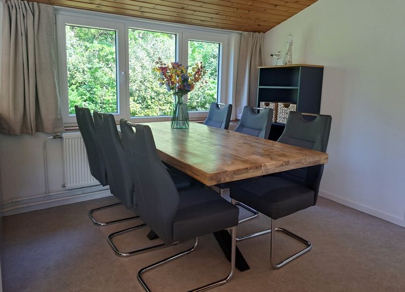 Eethoek in vakantiehuis Hoog Koog 10, Bungalowpark Hoog Koog, De Koog, Texel, Waddeneilanden met houten tafel.