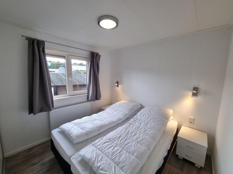 Comfortable bedroom in Chaletpark Bregkoog - Chalet 240 De Texelse Berg, De Koog, Texel with two single beds.